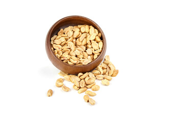 Wooden bowl filled with roasted peanuts, some scattered on a white surface, showcasing a healthy snack option and natural food presentation for culinary use