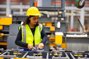 maintenance and service factory : indian female Professional Mechanical Engineer in safety hardhat Working Maintenance sheet metal roof tile roll forming machine at industrial manufacturing factory