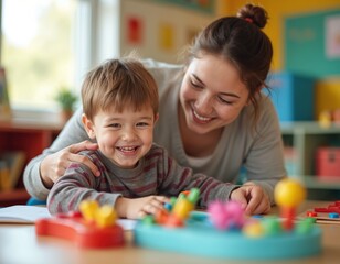 Joyful autistic boy studies, learns, plays with teacher in classroom. Supportive inclusive education environment. Happy child in special needs school smiles, looks. Child with autism, tutor.