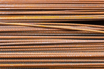 Rust-covered metal rebar rods stacked at outdoor construction site