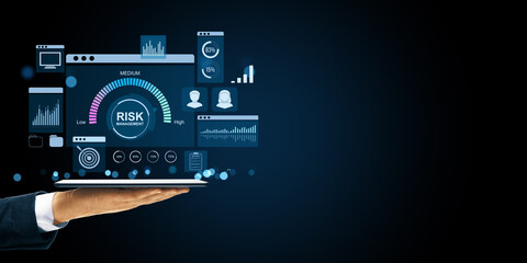 Risk management dashboard interface displayed on tablet by businessman, showing financial data and analytics tools in digital environment.