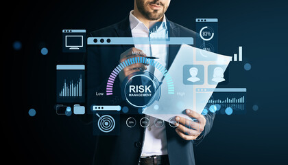 Businessman analyzing financial risk management data using digital dashboard interface on light tech background for corporate finance concept.