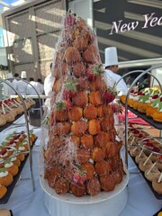 Elegant Croquembouche Dessert with Strawberries on a Festive Table Setting