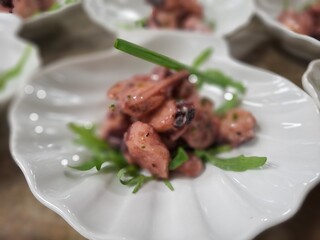 Elegant Presentation of Gourmet Octopus Salad in a Fine Dining Setting