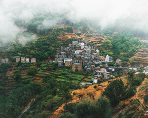 A tiny town among cascades of fields in the middle of a foggy day (Pi&oacute;d&atilde;o - Portugal)