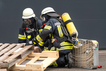 Fire rescue operation – woman rescued behind pallet. Combination of fire protection and technical...