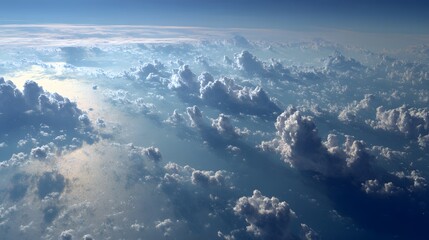 Scattered clouds over ocean seen from high altitude.
