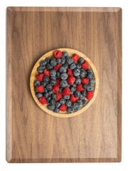 The High resolution fruit photo of mixed fruits including cherries, raspberries and blueberries arranged on a plate, taken with split focus technique.
