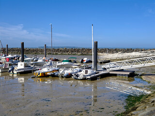 Port of Chatelaillon-plage in low tide and reflections on the surface of the remaining water. Châtelaillon-Plage is a commune in the Charente-Maritime department