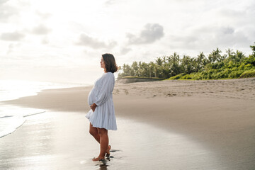 Pregnant woman in silent reflection represents thoughtful entry into motherhood, aligned with tech...