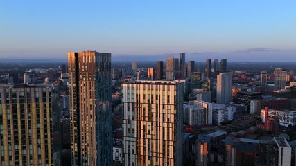 Aerial video over modern high-rise apartment buildings in Manchester at Sunrise  - Powered by Adobe