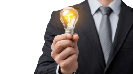 Businessman holding a glowing light bulb as a symbol of ideas and innovation, white isolated background.
