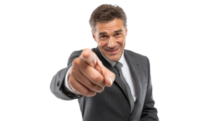 Confident businessman pointing and smiling, dressed in a sleek suit, isolated on a white background.