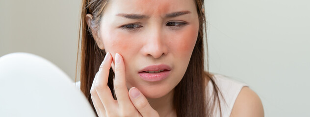 Dermatology, puberty asian young woman, girl looking into mirror, allergy presenting an allergic...