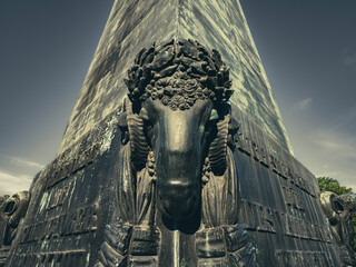 Close-Up of Bronze Ram Head Ornament on Historic Obelisk Monument in Munich, Germany