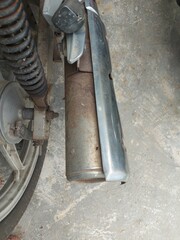 Old Metal Motorbike Muffler with Rust and Chrome Detail