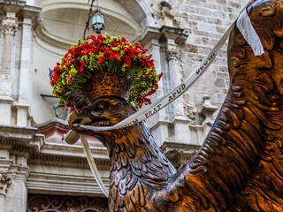 Statue of a large eagle with a ribbon in its beak on Corpus Christi Day in Valencia against the...