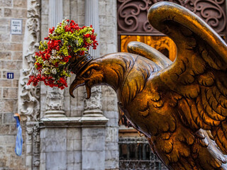Statue of a large eagle on Corpus Christi Day in Valencia against the wall of a church