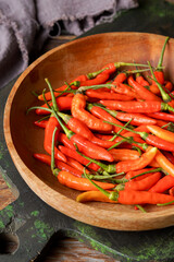 Fresh Red Bird’s Eye Chilies on Rustic Surface for Spicy Cooking and Asian Food Concepts