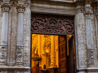 Church entrance with beautiful ornaments and carved and forged images in Spain