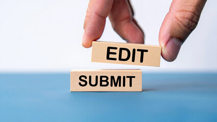 A hand holds a wooden block labeled edit above another labeled submit