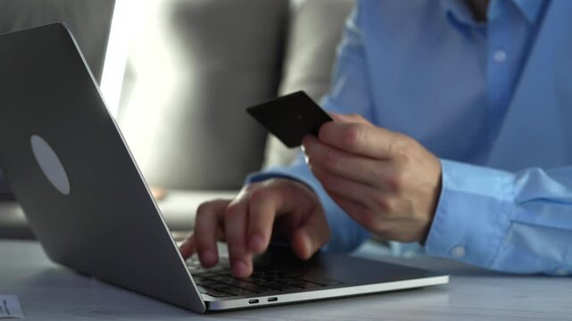 A man in the office uses a bank credit card to pay for goods.
Online shopping and online product, Money and finance.
Using a bank credit card.
Cash payment