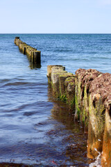 Tranquil waves roll onto the Baltic Sea shore under a wide open sky — a peaceful moment by the...