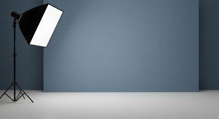 A photography studio setup with a softbox lighting a blue wall