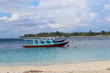 Traditional Boats Floating on Blue Sea Near Sandy Beach in Gili Trawangan, Lombok Indonesia. with...