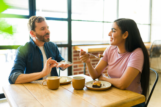 Couple enjoying coffee and cake at a cafe