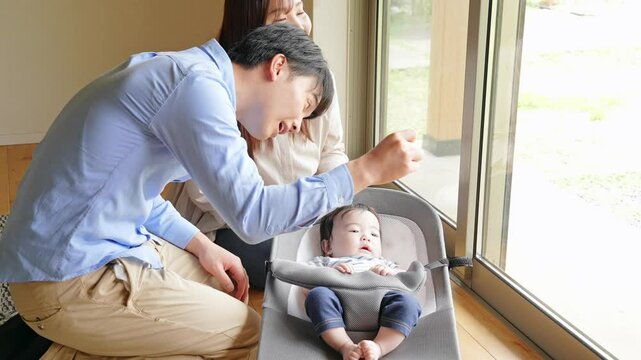 Couple looking after a baby in a room