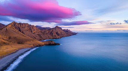 Breathtaking coastal landscape featuring rugged mountains, serene ocean, and vibrant sky at sunset, evoking sense of tranquility and adventure