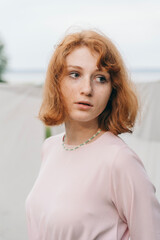 Redhead Woman Wearing Handmade Beaded Daisy Necklace and Pink Dress