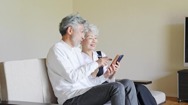 Senior couple looking at smartphone together