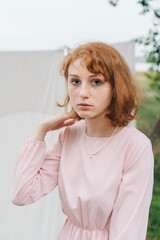 Redhead Woman in Pink Dress Wearing Minimal Necklace Outdoors