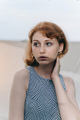 Close-Up Portrait of Redhead Woman with Gold Hoop Earrings