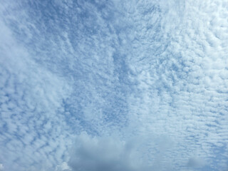 Blue Sky with White Fluffy Clouds. Natural Background for Weather, Nature, and Travel Concepts....