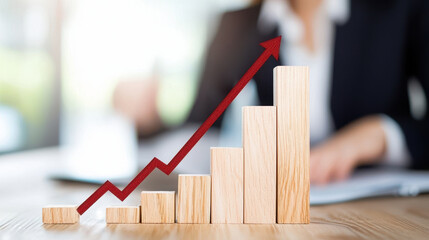 Increasing business growth is represented by wooden blocks and red arrow, symbolizing success and progress in professional setting