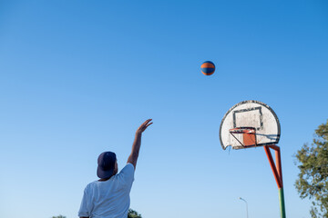 Man seen shooting basketball towards hoop