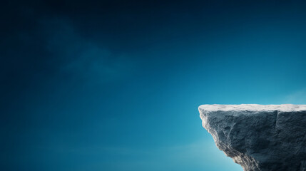 Rugged cliff edge stands against serene blue sky, evoking sense of tranquility and isolation