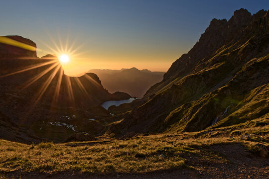 Sun light at sunset on Lake Crozet from La Pra mountain pass, with the backdrop of the Chartreuse massif