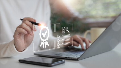Businesswoman working on quality assurance and document compliance check using a laptop and digital checklist. Online certification and standard validation.