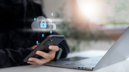 Hand holding smartphone with cloud security icon and data transfer arrows. Concept of cloud...
