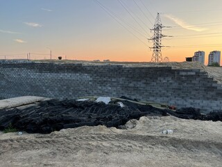 Newly erected road junction wall on the bridge made of concrete or cement blocks. Against the...