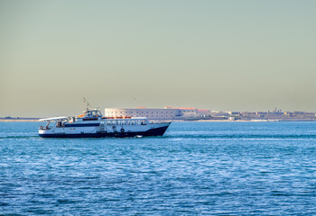 A lonely little sea vessel in the sea on the horizon.