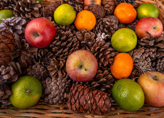 Fruits among pine cones in close-up.