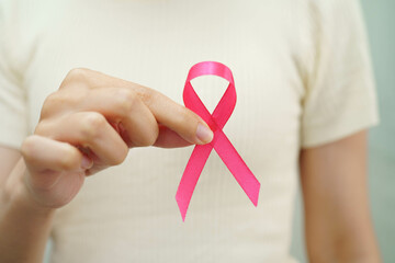 Asian woman with pink ribbon for October world breast cancer day.