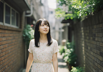Fototapeta premium Young Japanese Woman Walking in a Peaceful Alleyway