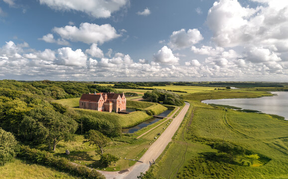 Aerial summer panoramic landscape view of Sp&oslash;ttrup Borg, Denmark&rsquo;s best-preserved medieval castle, surrounded by double moats and lush countryside near Limfjord. 