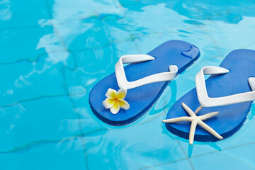 blue flip flops on the pool water